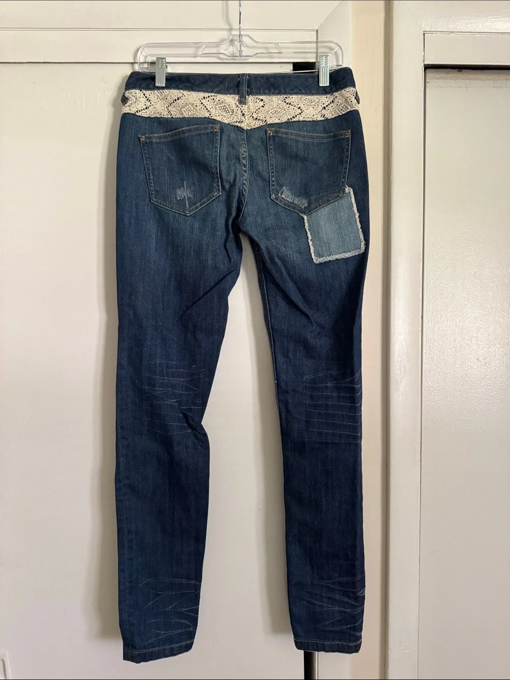 Free People skinny jeans with crochet lace and patching details. 32” inseam.